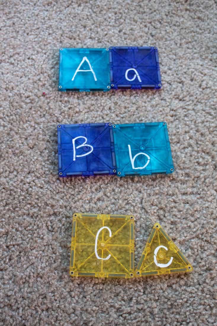 Magnetic tile activity with upper and lower case letters written on the tiles and matched.