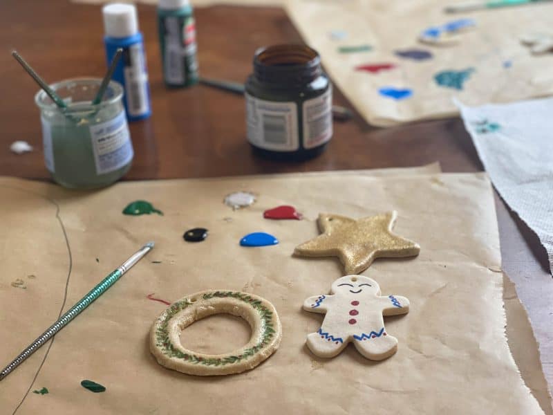 Wreath, star, and gingerbread salt dough ornaments being painted