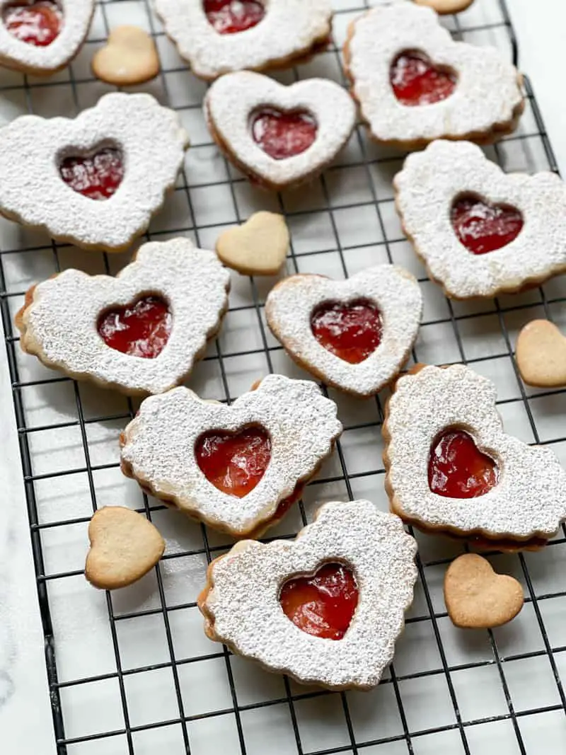 Heart-shaped Strawberry Jam cookies on a cooling rack
